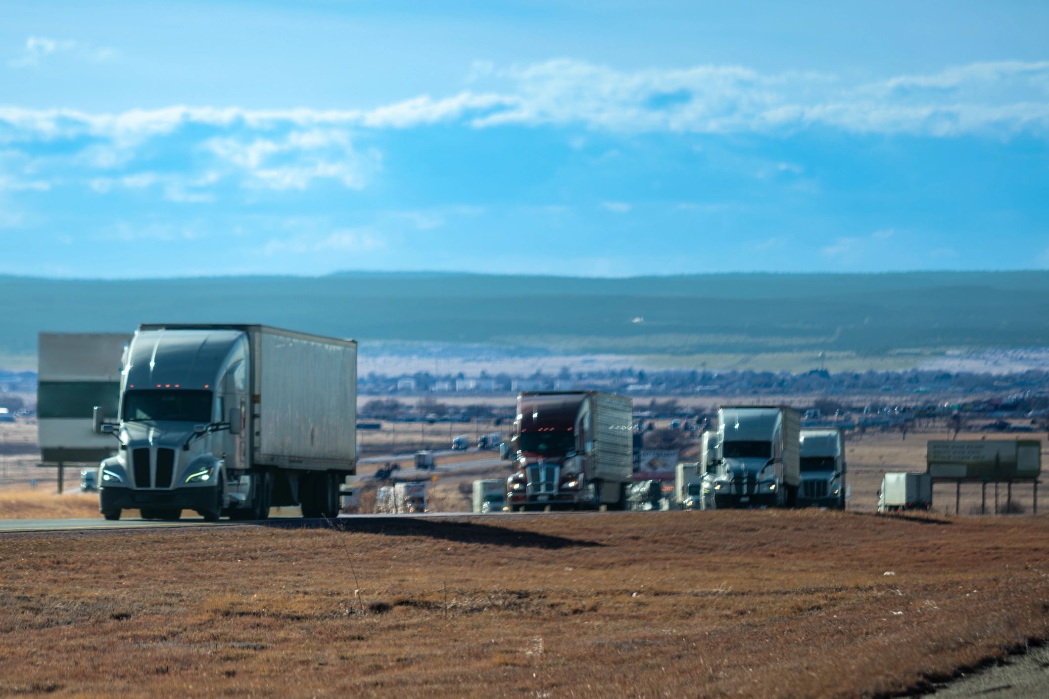 Commercial trucks parked in an open landscape